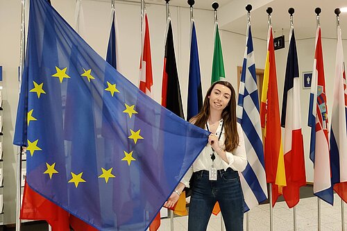 Chelsea Whyte with the flags of the EU