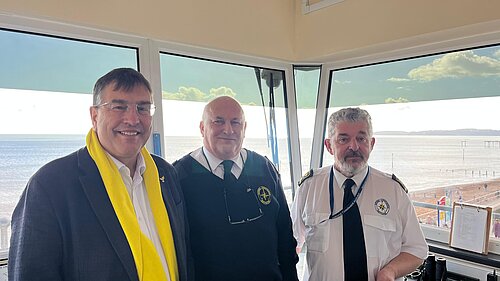 Image of 3 men in a coastwatch station