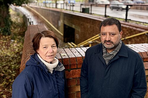 Hilary and Mahmoon next to flooded subway