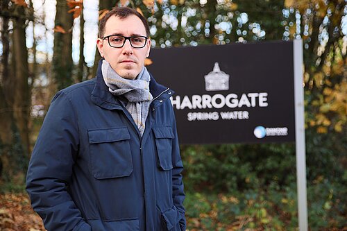 Tom Gordons stood by a Harrogate Spring Water sign