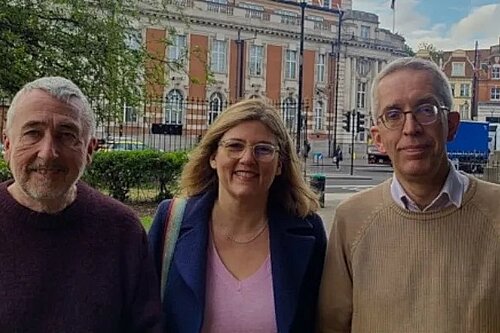Photo of three people, two men and a woman