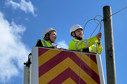 Helen with a broadband engineer in a cherry picker truck