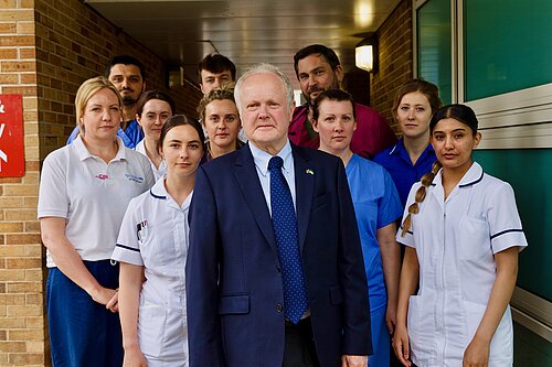 Clive Jones outside the RBH surrounded by NHS Staff