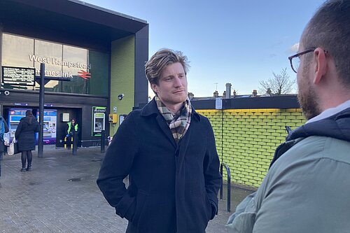 Patrick speaking to resident outside Thameslink Station