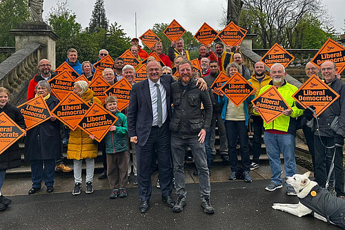 Ed Davey and Lib Dems with placards celebrate 2026 elections results
