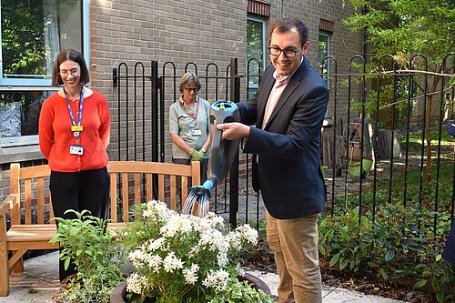 Tom Gordon watering plants on his visit to Harrogate Hospital and Community Charity