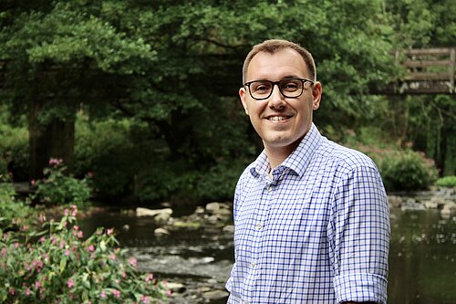 Tom Gordon MP standing in front of a river