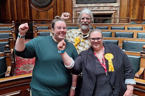 Rachel Sutherland, Alun Griffiths and Aislin Naylor celebrate in Town Hall chamber