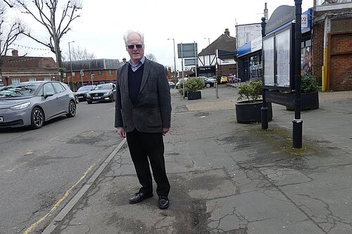 Simon standing on broken pavements