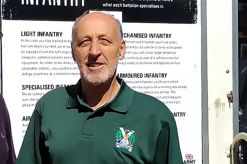 Cllr David Down stood in front of Armed Forces Covenant banner
