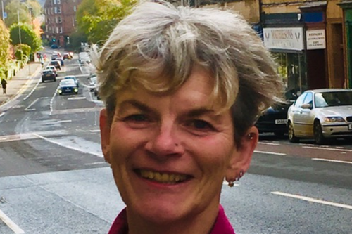 Pauline standing with a road in the background