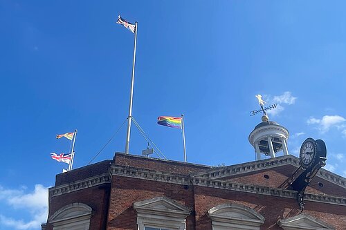 The Armed Forces Day and Pride flags fly together with the Union flag and Maidstone Borough flag over Maidstone Town Hall.