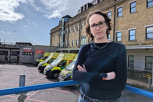 Alison in front of ambulances 