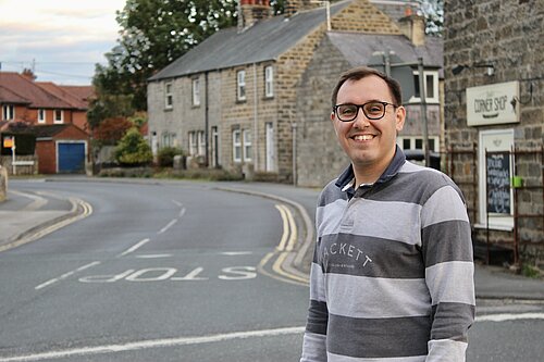 Tom gordon MP on street corner 