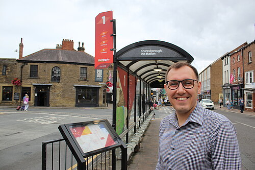 Tom Gordon MP at a bus stop in Knaresborough