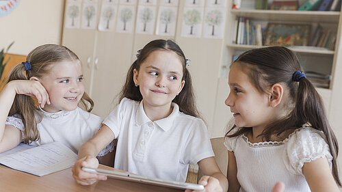 Three children in a classroom