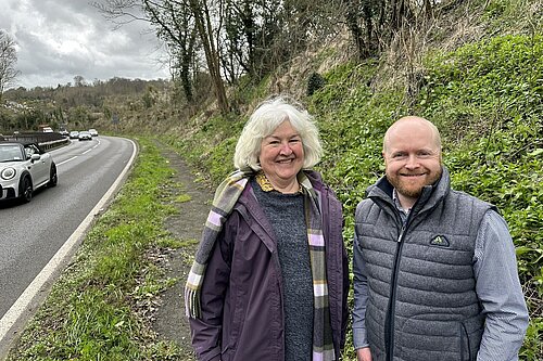 Two people standing next to A22