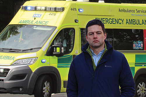 Chris by an ambulance