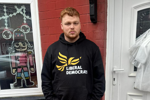 Connor Stallard - Lib Dem stood infront of a door