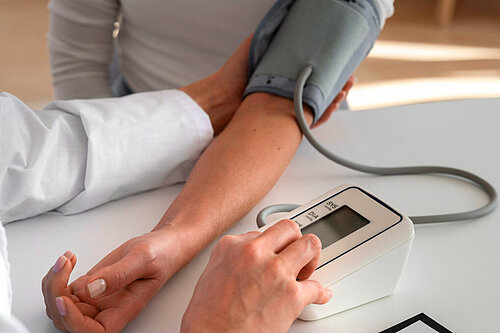 A picture of someone have their blood pressure checked 