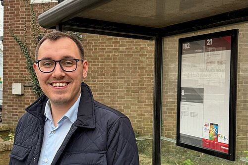 Tom Gordon stood at a bus stop