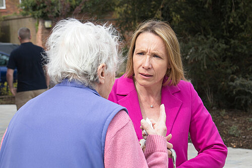Helen speaking to a very concerned pensioner