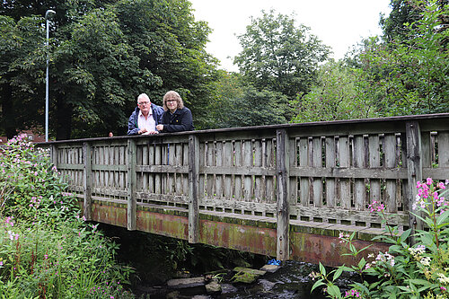 Cllr Howard Sykes MBE and Cllr Tom Penketh on a bridge over the River Beal 