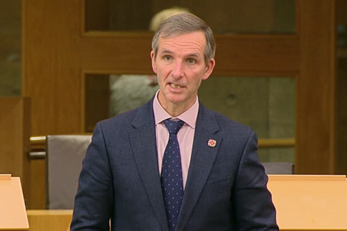 McArthur speaking in the chamber.