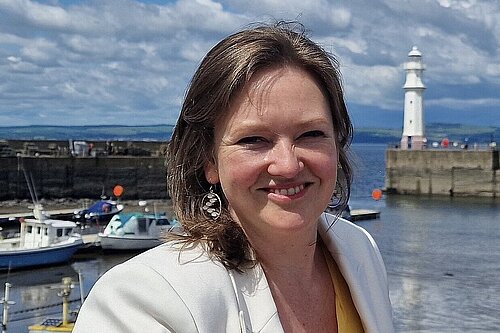 Sanne with Newhaven Harbour and Blue skies in the background