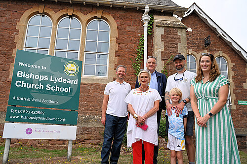 Rachel Gilmour and representatives from Bishops Lydeard Church School and Bishops Lydeard Parish Council outside of the school building