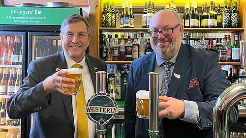 Image of two men behind a bar