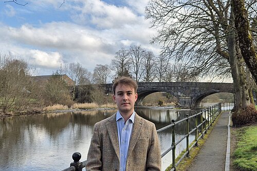 Cllr Glyn Preston in front of the River Severn in Llanidloes