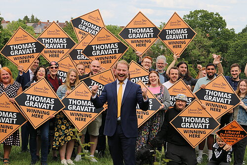 Thomas Gravatt with a group of cheering Lib Dems