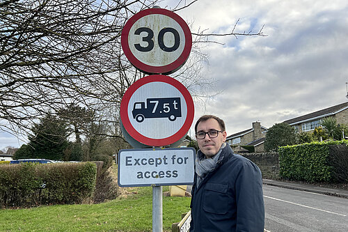 Tom Gordon stood by a 30 speed limit sign 